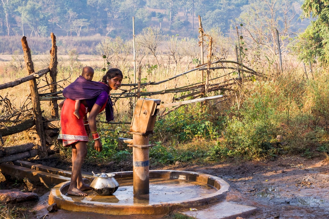 People beside a community water pump