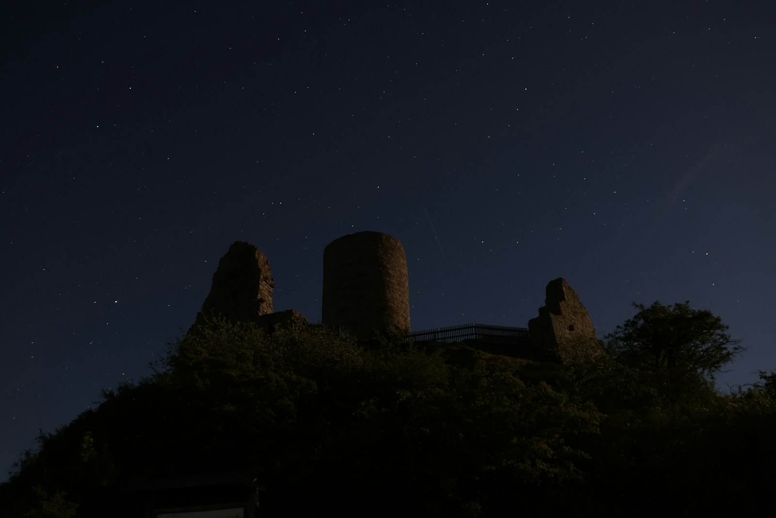 A castle silhouetted against a starry night sky, illustrating the mystery of parallel universes.